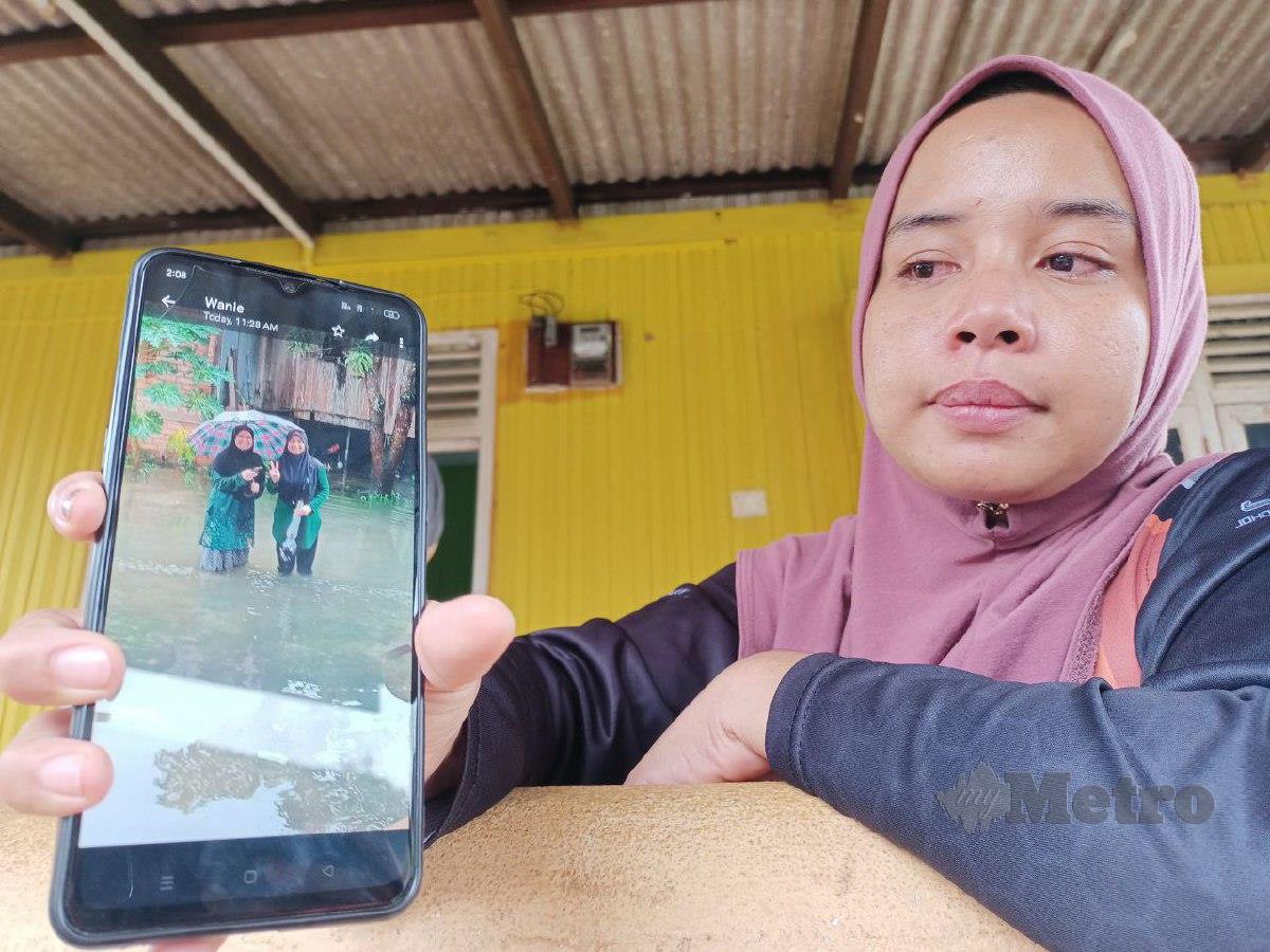 SEPUPU mangsa, Nor Nadia Abdul Alin, 32, menunjukkan gambar arwah Nor Syazwani (kanan) dan adiknya, Nurul Fatiah sebelum tragedi berlaku. FOTO Siti Rohana Idris