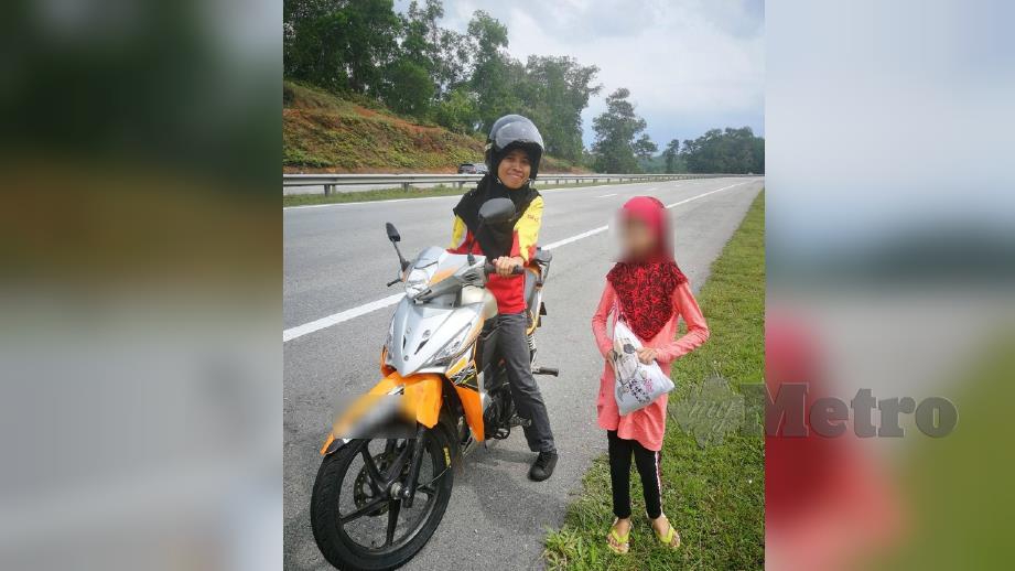 PEKERJA stesen minyak bersama anak seorang wanita yang tertinggal di R&R.  FOTO Ihsan Twitter @Sutungmenjerit