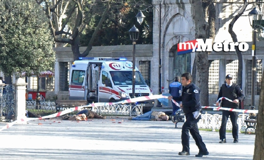 epa05098328 Policemen secure the area next to dead bodies after an explosion near the Blue Mosque, in the Sultanahmet district of central Istanbul, Turkey, 12 January 2016. Ten people are dead and 15 injured following an explosion in the Sultanahmet district of central Istanbul, the Anadolu news agency reported, citing the city's governor. According to the report, government sources suspect the explosion was intended as a terror attack. Police believe a suicide bomber was to blame, broadcaster CNN Turk reported.  EPA/STR ATTENTION EDITORS: GRAPHIC CONTENT. TURKEY OUT