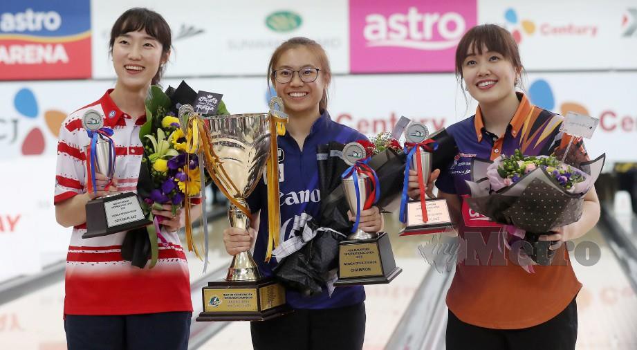 Juara terbuka wanita dari Singapura, Charlene Li (tengah), naib juara dari Korea Selatan, Sung Gyong Eun (kiri) dan ketiga dari Malaysia, Sin Li Jane (kanan) bersama trofi. 
